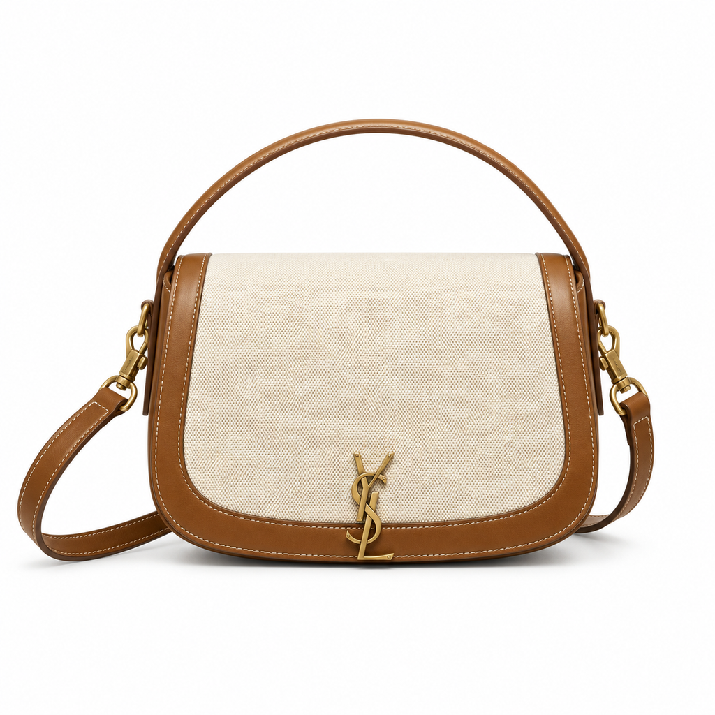 Saint Laurent Solferino satchel in ivory canvas with tan cognac leather trim, gold YSL monogram, top handle and crossbody strap