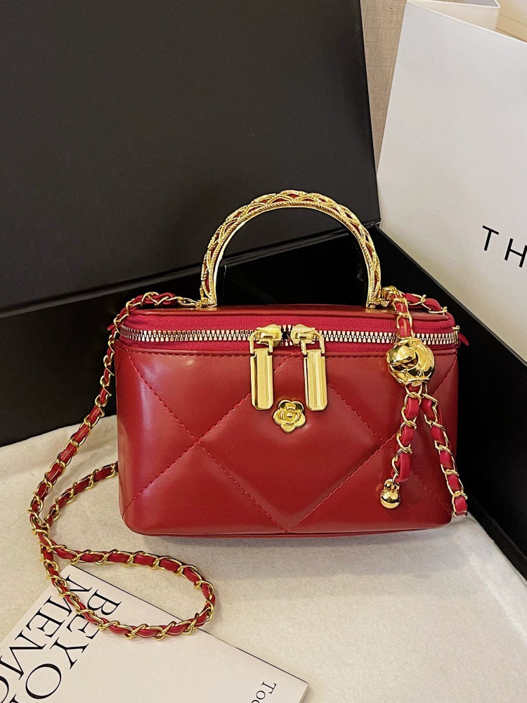 Red Diamond Quilted Vanity Box Crossbody Bag with Gold Braided Top Handle Camellia Zipper Pull Gold Ball Tassel and Interwoven Chain Strap